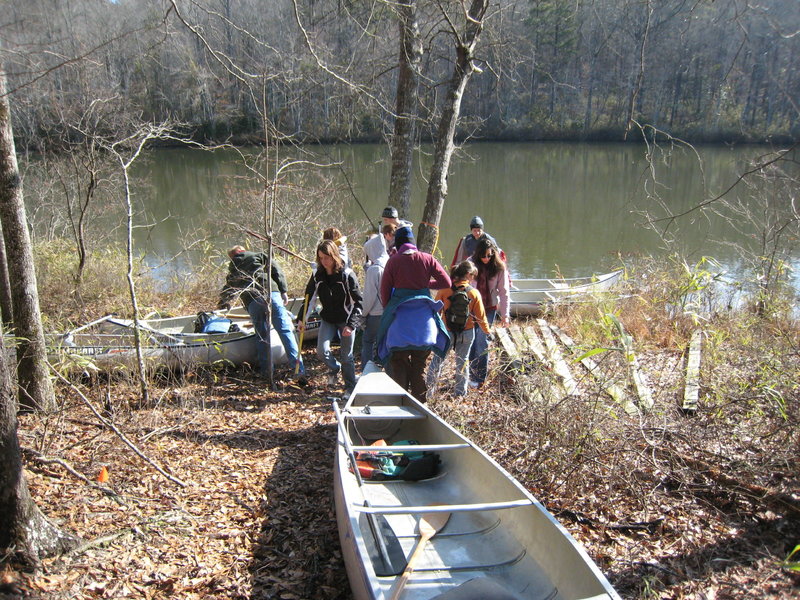University of Alabama Honors College trail work crew transporting material to replace the "bridge to far". Due to the remoteness of the west side of the park often the easiest or only way to get to a work site is to cross the lake by boat or canoe then hike.