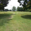 Head up this small hill (and remains of an old bmx course) and around the back of the softball field.