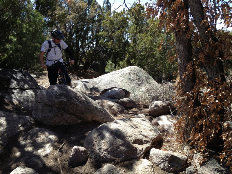 Lance trying to figure out what to do with the embedded boulders