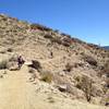 Riders crossing the stone bridge on the back side of the first mound.