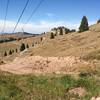 When you reach the top of the Poma lift, do NOT go down the road.  Look for a singletrack that proceeds at a level altitude straight across.