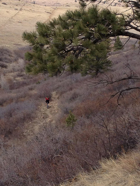 Looking down on a gradual descent with some rocks along Dowdy Draw.