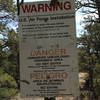 A closer view of the sign that is hidden in the trees. I actually have my back against a tree to take this photo.