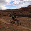 Rolling along the singletrack section nearest the edge of the rim.