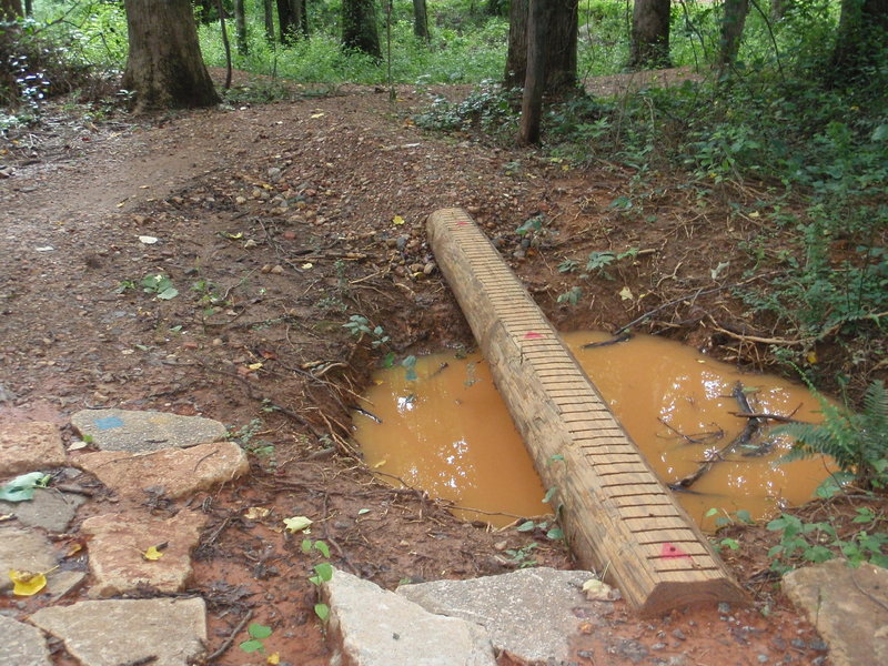 log skinny over a hole, lots of rain lately