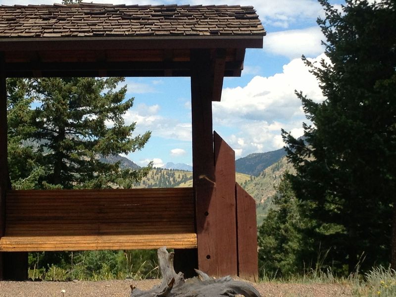 A memorial rest stop with a surprise view of Longs Peak way off in the distance.