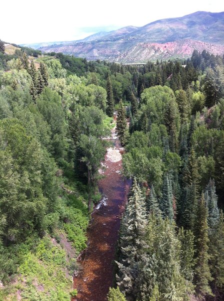From Tiehack Bridge, Maroon Creek trail is hidden in the trees to the left of the Creek.  MC trail ends after a short climb just beyond the Highway 82 bridge in the distance.