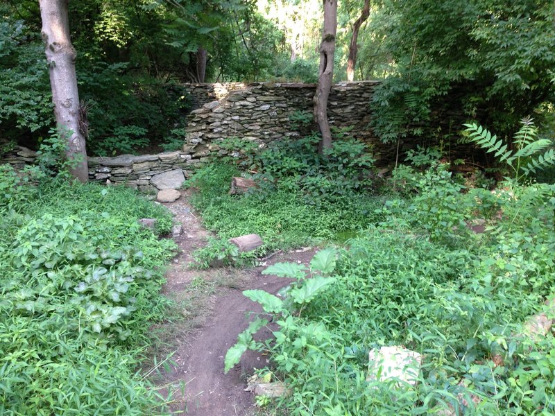 Path over wall and through farmhouse