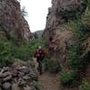 Riding through a narrow gulch along the trail