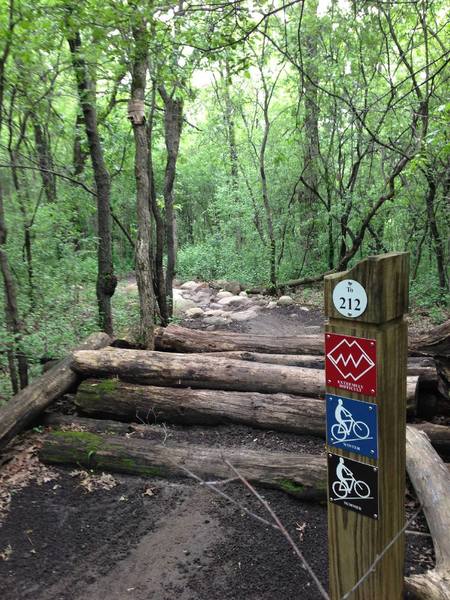 One of many log piles and rock gardens.   This is the entrance (filter) to the XX loop.   (also showing off the great signage available out on the trails)