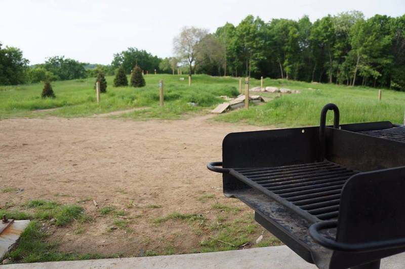 Looking out at the skills park past one of the grills available for use at the brand new trailhead facilities (as of 2012).