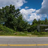 The trail continues left of the crumbling and overgrown shack. There is no trail marker.