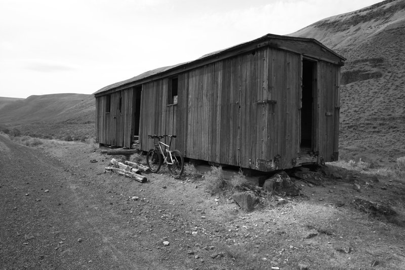 A decrepit old railcar sits along side the rail trail near mile six.