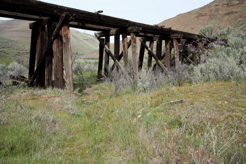 Rolling by a large wood trestle.