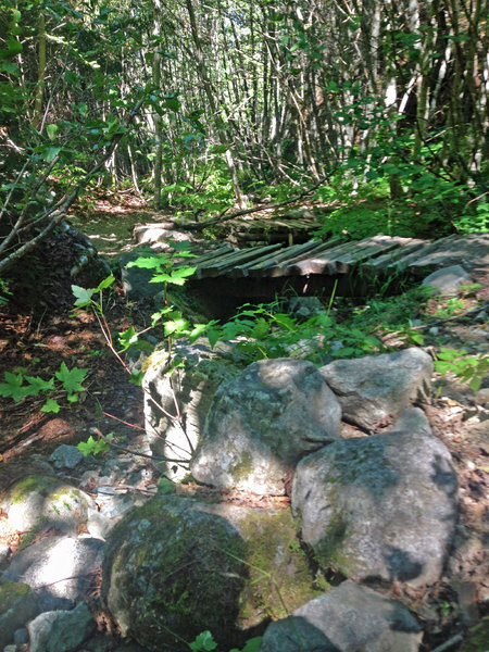 A series of bridge switchbacks following a creak upstream.