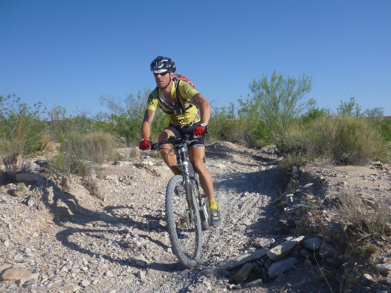 Alex riding the creek bed section at the top of loop 3.