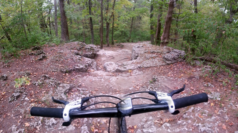 Looking down the large exposed limestone rocks known as "The Steps". Depending on your line through this section, the rider could take up to a 2' drop.