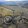 The view north from the bluffs at the top of the Zipper. You can see the Zipper trail switchbacking down the slope behind and Golden Eagle Sports Complex in the background. Just right of the handlebars in the photo is Graffiti Rock.