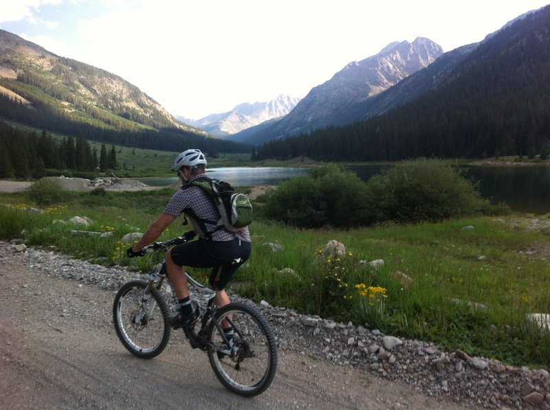 Riding past Grizzly Reservoir along Lincoln Creek Rd.  The road wraps around and continues towards the central horizon.