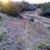 Descent to the arroyo crossing is steep and slick