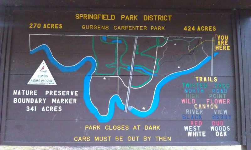 Park map board next to pavilion.  Notice areas with the white boarder and white triangle.  These are Nature Preserve areas where riding is not allowed.  Please do not ride hiking trails! Hike and run at will.