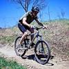 Dropping into Barn Dance from the trailhead. Bike wheel sign totem pokes up over the hill.