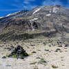 A rock cairn marks the route with Mt. St. Helens in the background.