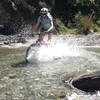 Getting wet on one of a dozen rideable stream crossings on this trail.