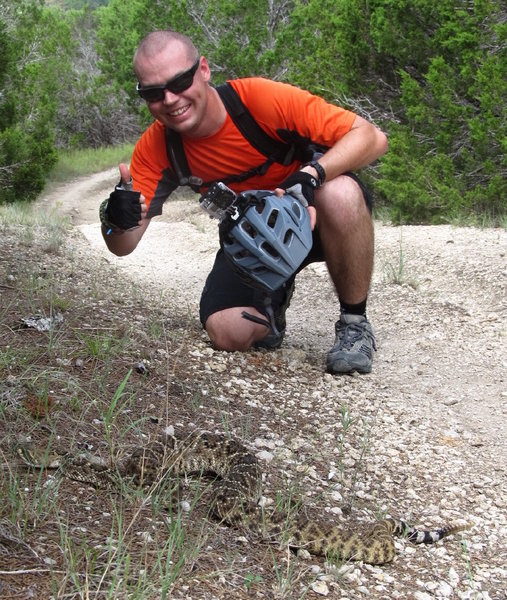 Taylor and a large Eastern Diamondback Rattlesnake along the Fence Line Trail at the Dana Peaks Trail System