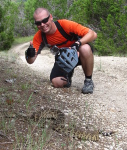 Taylor and a large Eastern Diamondback Rattlesnake along the Fence Line Trail at the Dana Peaks Trail System