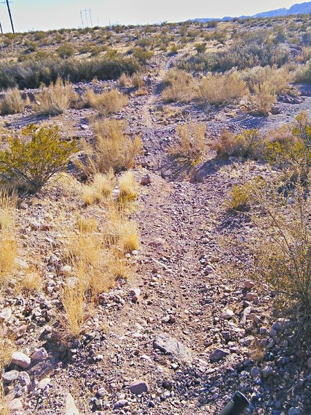 Typical arroyo crossing with loose gravel and some erosion on the banks