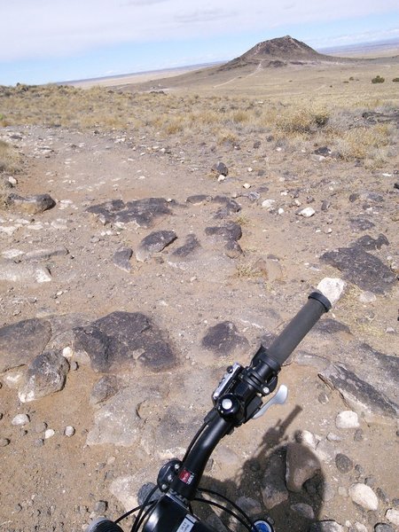 Looking north towards "Vulcan" volcano. Embedded volcanic boulders add interest to the singletrack.