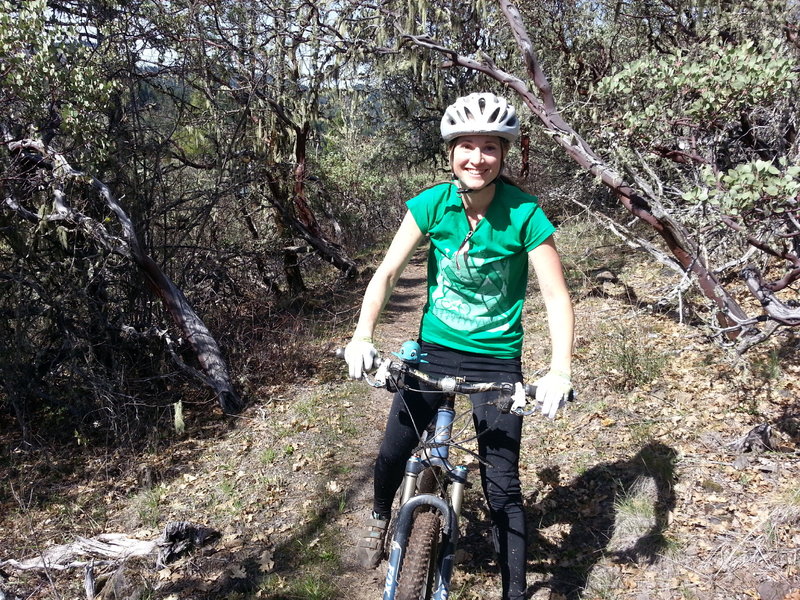 Robyn riding through a Manzanita tunnel