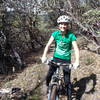 Robyn riding through a Manzanita tunnel