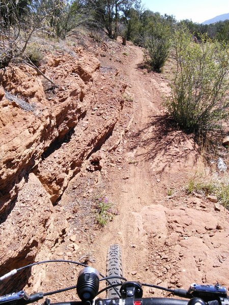 Narrow trail going in to a tight arroyo V-turn