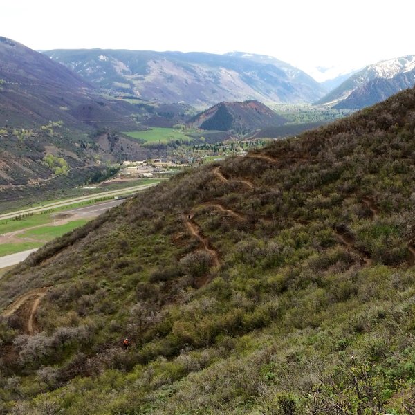 Airline Trail with tiny riders and big berm turns.  Airport runway, Red Butte & City of Aspen beyond.