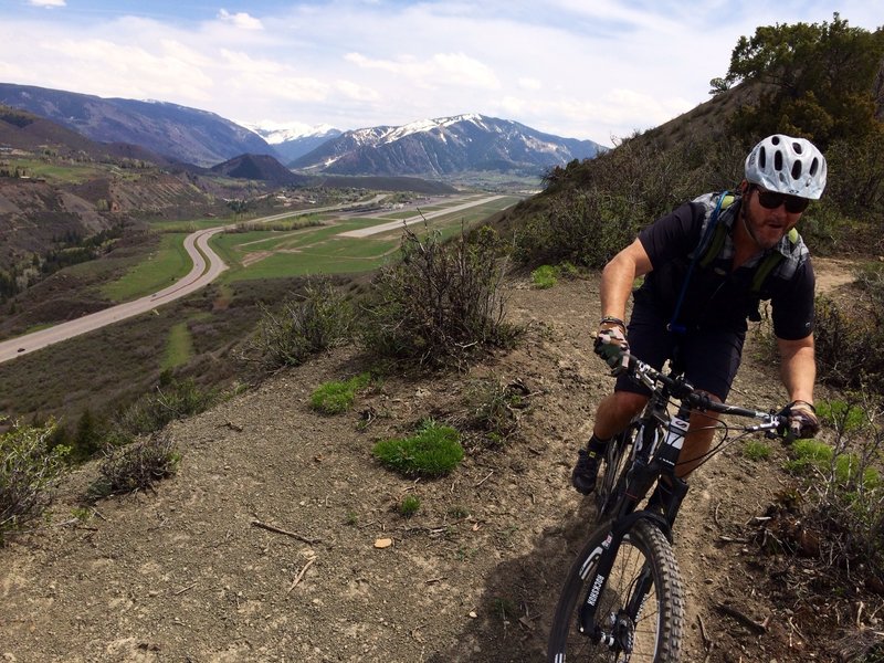 Smiling Ed on Cozline Trail just above Shale Bluffs with Hwy 82, airport runway and City of Aspen in the distance.