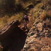 Hell Creek Loop near the 14 mi mark on the main big loop. The picture is taken from a biker's eye view from a trail segment that is on a ledge directly above where this rider is.