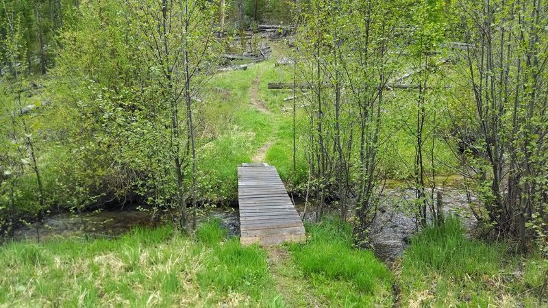 The bridge over the creek lets you know your descent has ended and just the short climb to the road remains.