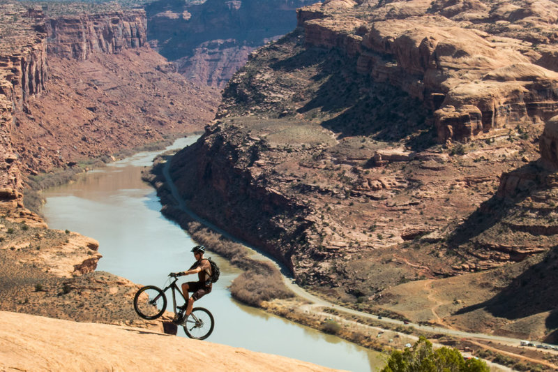 You can see the last section of the Porcupine Rim trail in the background. Wheelies are fun.