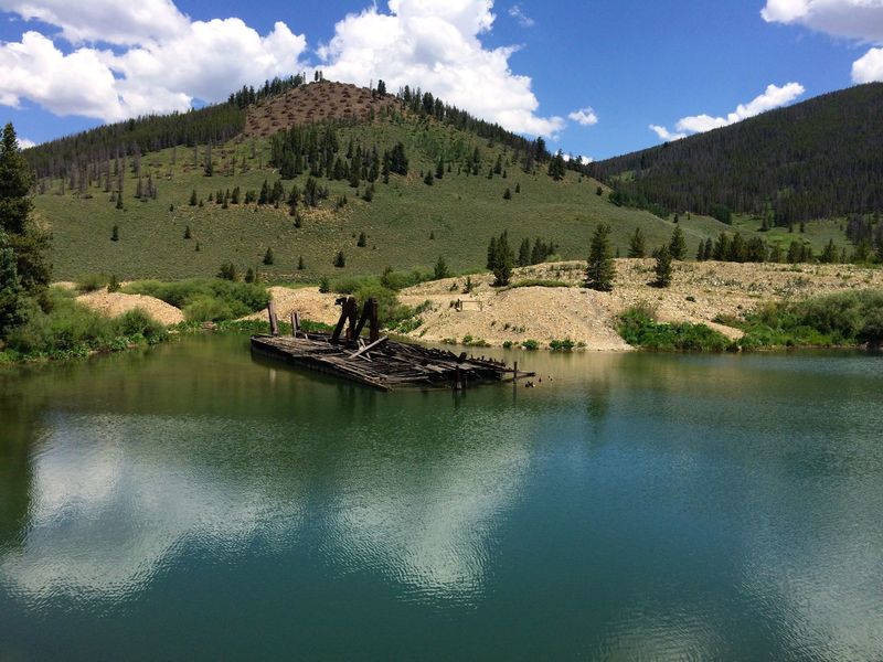 One of the historic dredge boats from the early 1900's the piled up mountains of river rock in the search for gold flakes.