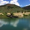 One of the historic dredge boats from the early 1900's the piled up mountains of river rock in the search for gold flakes.