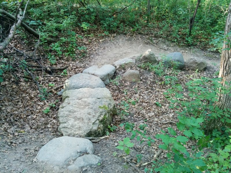 A rock bridge. This x loop has a little of everything. Rock rollers, downhill rock gardens, platforms, skinnies, a jump, etc.