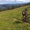 Cruising up Mid Vail Escape with the Gore Range in the distance.