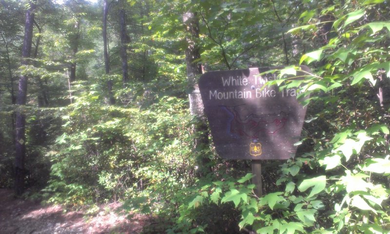 Trail entrance sign. Difficult to see from the road.