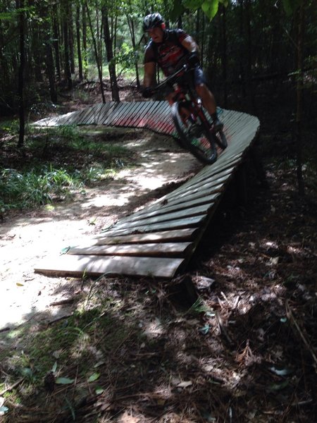 Local rider blasts around a banked board turn.