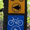 Example of yellow and blue corrugated plastic signs used to mark River Bends Park trails.