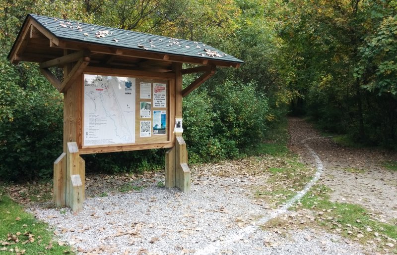 Trailhead kiosk. White painted line is for a cross-country running race and leads to the start of the singletrack.