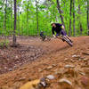 Elias and Joey taking a berm on the Sparkleberry downhill flow trail.
