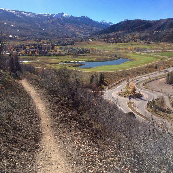 Looking southwest along the trail with Snowmass Rodeo Lot and roundabout nearby.